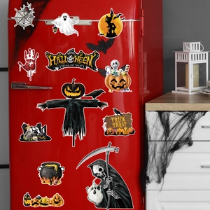 Magnetic Halloween gnome and skeleton stickers decorating a red refrigerator door