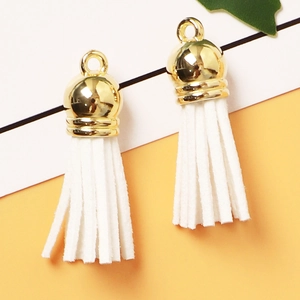 Two white suede tassels with golden metal caps and rings for DIY jewelry accessories