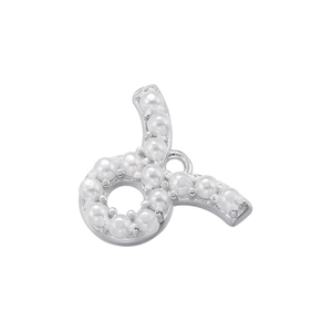 Detailed view of silver zodiac charm with inlaid pearls and top ring for DIY jewelry