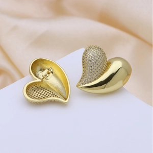 Elegant 18k gold plated heart studs with sparkling cubic zirconia on satin background
