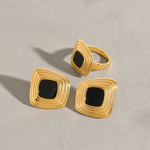 Vintage art deco jewelry set with black enamel squares and gold plated tiered metal