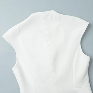 Detail view of the white sleeveless vest back with sharp waist seams and fabric texture