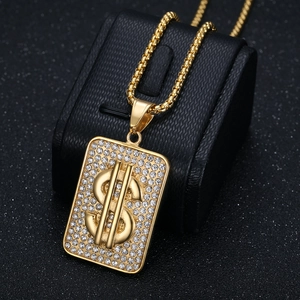 Hip hop gold plated dollar sign pendant necklace with sparkling diamonds on a black stand