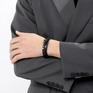 Detail of multilayer men's braided leather bracelet with black stainless steel buckle