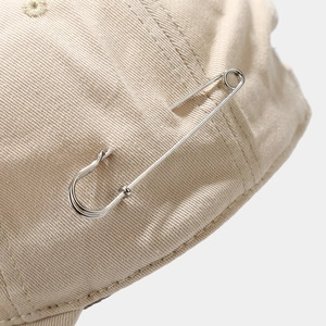 Streetwear beige cotton baseball cap featuring unique silver metal pin decor detail