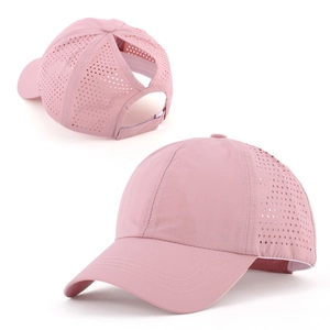 Detail of breathable laser-cut holes and high ponytail opening on rose pink quick-dry cap