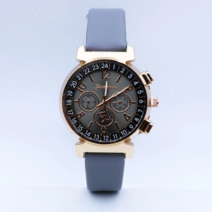 Detailed view of the quartz watch's sunray dial with decorative sub-dials and leather strap