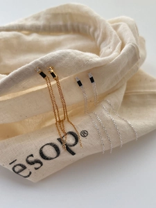 Detail of 925 sterling silver tassel earrings with black zircon in gold and silver finish