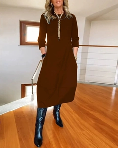 Detail of loose dark brown long sleeve midi dress with a round neckline on model