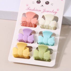 Set of six matte bow hair clips in assorted macaron colors displayed on a card