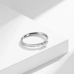 Titanium steel heart-shaped ring with 'I LOVE YOU' engraving on a white display pedestal