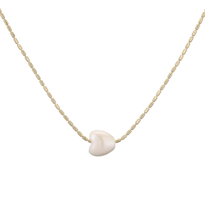 Minimalist gold chain necklace with a creamy white heart ceramic bead pendant