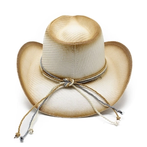 Detail of western straw cowboy hat featuring ethnic bull head accessory and braided rope band