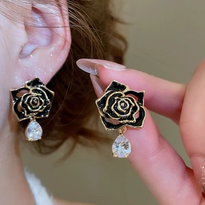 Close-up of vintage black rose stud earrings with transparent zircon water drop pendants