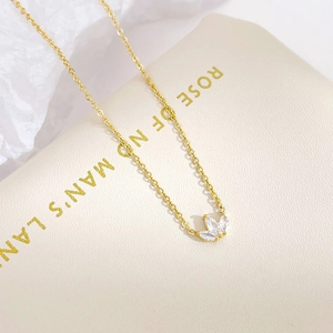 Elegant gold necklace featuring clover pendant with marquise-shaped white zircon stones