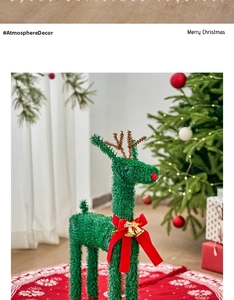 Detail of Christmas reindeer ornament with red bow, gold bell, and green velvet finish
