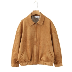 Detail of tan faux suede jacket with zipper closure and side pockets hanging on hanger
