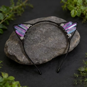 Macro shot of cat ear headband featuring colorful crystal prisms on dark rock base
