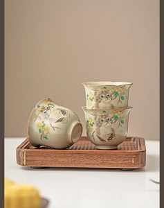 Detail of Ru Kiln ceramic tea cups with cat pattern and ice-crackle glaze on wooden tray