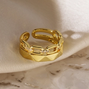 Macro shot of double-layered 18K gold-plated ring with zircons on silk and marble