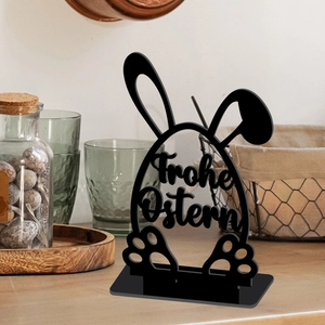 Close-up of black hollow acrylic Easter bunny egg ornament with Frohe Ostern text