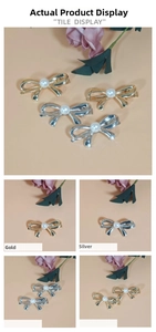 Detailed macro view of gold and silver velvet bow hair clips with white pearl centers