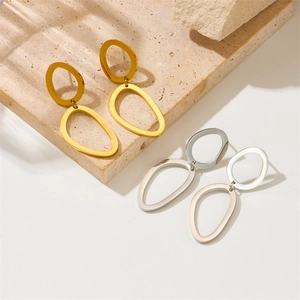 Minimalist geometric double oval gold and silver stainless steel earrings on marble background