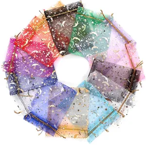 Detail of colorful organza gift bags with gold foil star and moon patterns and ribbons