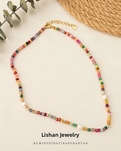 Macro detail of colorful faceted natural stone beads and pearls on titanium necklace