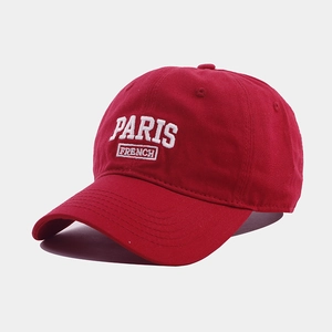 Detailed view of high-quality red cotton baseball cap with white PARIS FRENCH embroidery