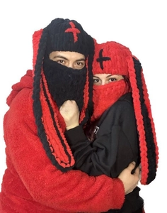 Detail of plush knitted balaclava with long rabbit ears and cross pattern on top