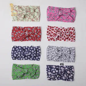 Set of eight soft nylon baby headbands with various sports ball prints and bow detail