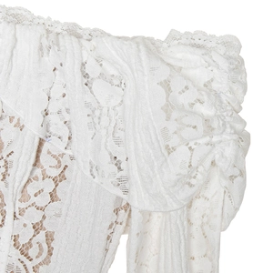 Macro detail of white lace texture and ruffled off-shoulder design on a slim dress