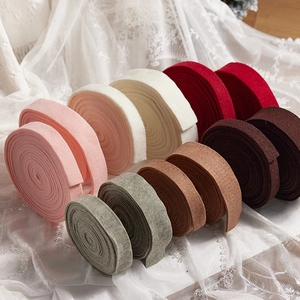 Thick wool felt ribbon rolls in pink, red, and brown for DIY Christmas decorations