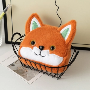 Detailed plush fox coin purse in orange fur, showcased in a black metal wire basket