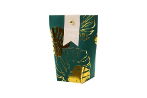 Detail of dark green wedding gift box featuring gold foil monstera leaves and Thank You tag