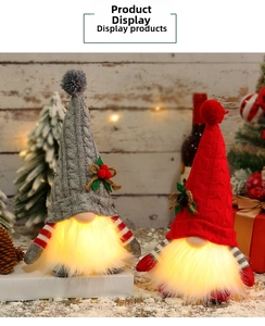 Close-up of glowing Christmas gnomes with warm LED lights and sequins in a festive setting