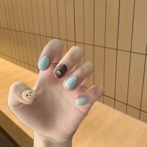 Cute cartoon bear and polka dot press-on nails in blue, brown, and beige tones