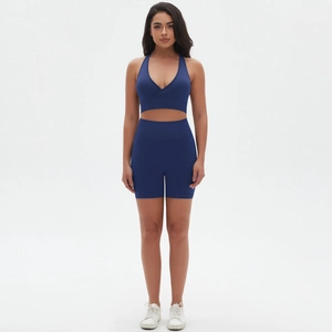 Set yoga blu scuro senza cuciture con reggiseno sportivo elastico e pantaloncini a vita alta