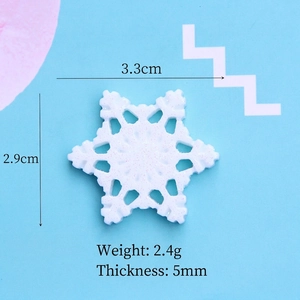 Macro view of a 3.3cm white resin snowflake accessory with glitter for DIY crafts