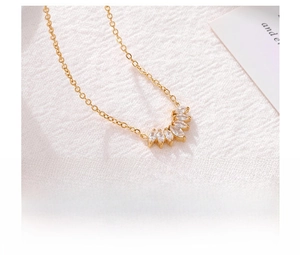 Detailed macro view of petal-shaped zircon pendant on a gold titanium steel necklace