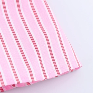Detailed macro view of pink and white striped fabric showing stitching and seam texture