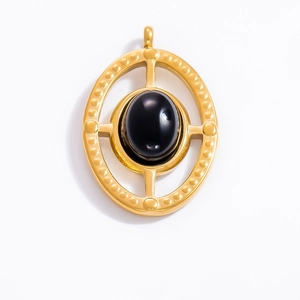 Detail of vintage 18k gold plated oval pendant with black obsidian stone and beaded edge