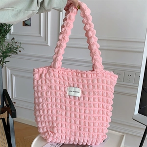 Detail of pink popcorn textured tote bag featuring a white LOVE SOZAKKA brand woven label