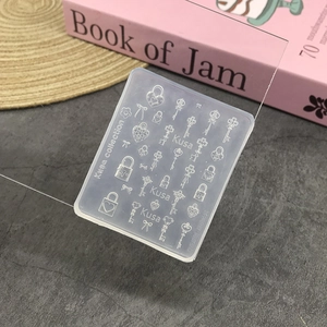 Macro detail of transparent silicone nail mold featuring intricate lock and key patterns