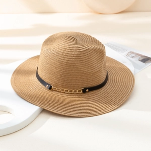 Detail of light brown woven straw fedora hat with black leather belt and gold chain decoration
