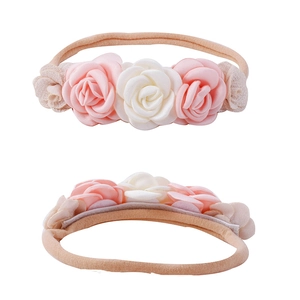 Detailed view of handmade fabric roses and elastic nylon headband for infant photography