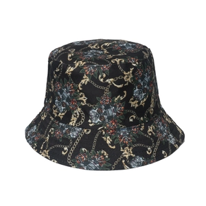 Punk style bucket hat with skull and gold chain graffiti patterns on black canvas
