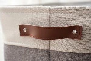 Macro shot of durable cotton linen fabric texture with leather handle and metal rivets