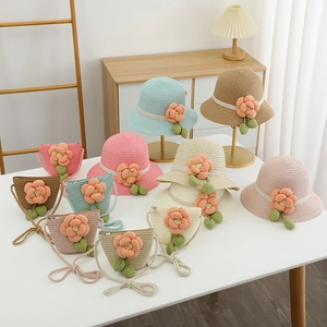 Details von bunten Kinderstrohhüten und Taschen mit handgefertigten Häkelblumen